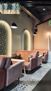 A cozy lounge area with retro pink and teal decor, inviting guests to relax.