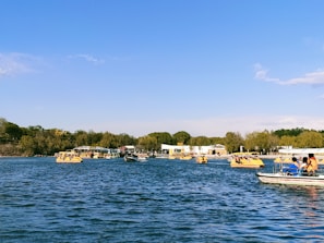 A group of friends enjoying a scenic boat ride on a crystal-clear lake.