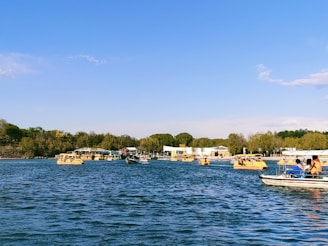 A group of friends enjoying a scenic boat ride on a crystal-clear lake.