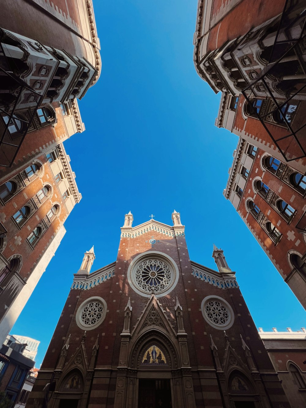 looking up at a church with a blue sky in the background