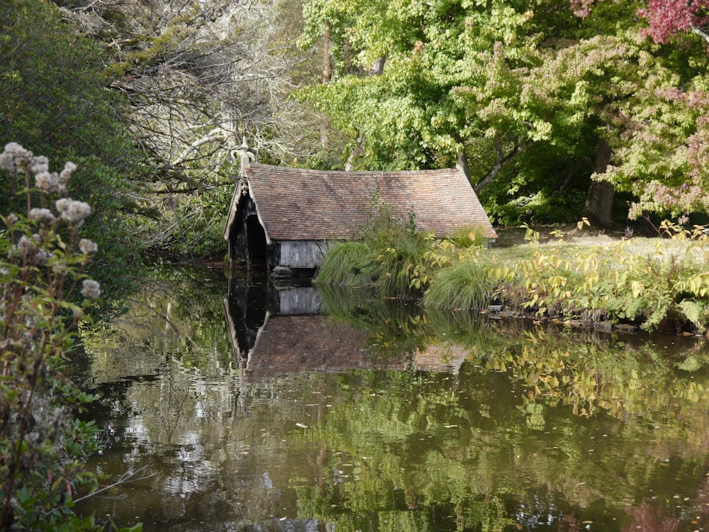 a small house sitting next to a body of water