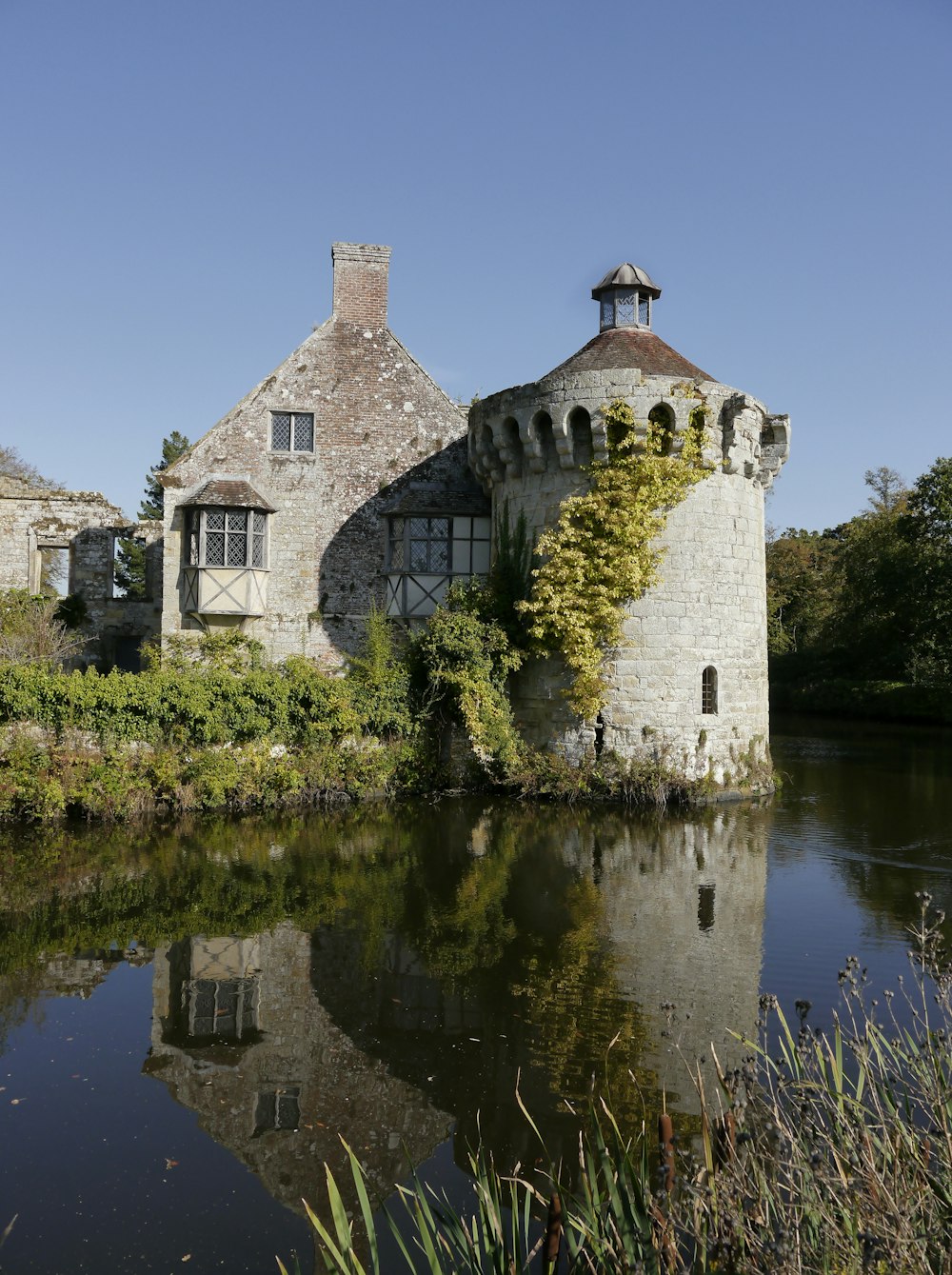 a castle with a pond in front of it