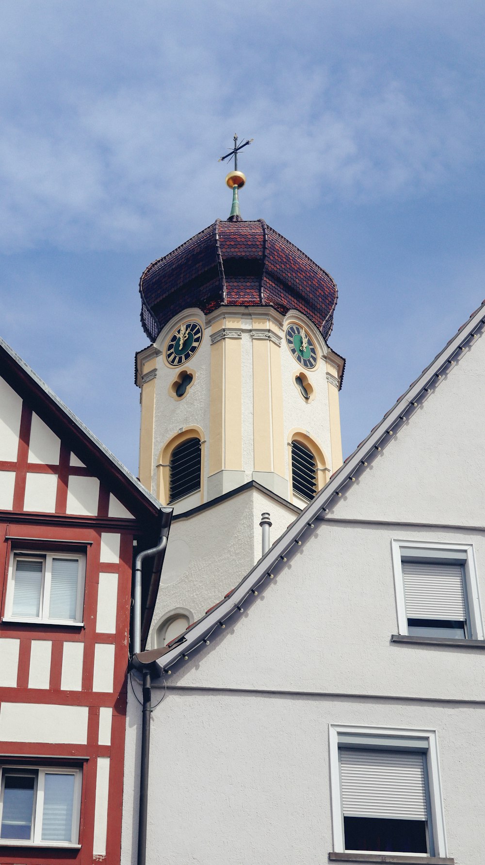 a church steeple with a cross on top of it