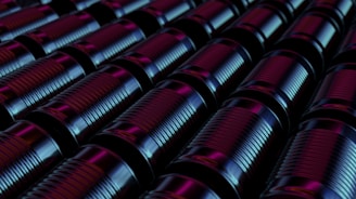 A neat row of shiny scrap metal pieces ready for recycling, glowing under soft green lighting.