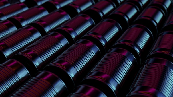 A neat row of shiny scrap metal pieces ready for recycling, glowing under soft green lighting.