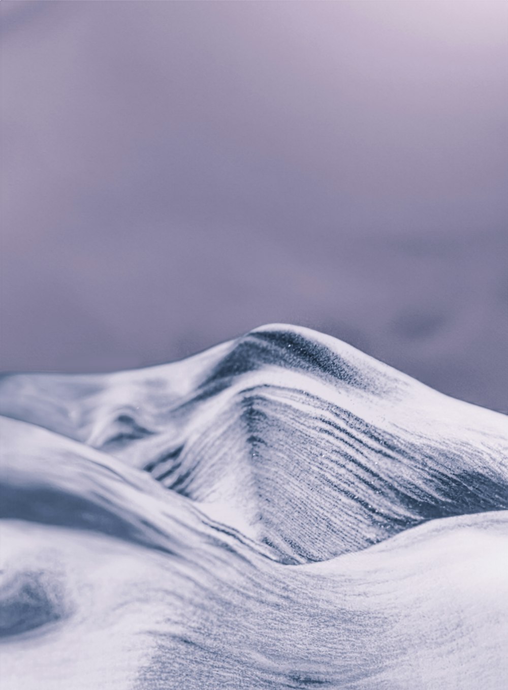 a black and white photo of a snow covered mountain