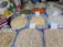 Various grains and legumes are displayed in open sacks, each labeled with a price tag. Items include chickpeas, lentils, beans, and other dry goods. There are also cleaning supplies and paper towels in the background.