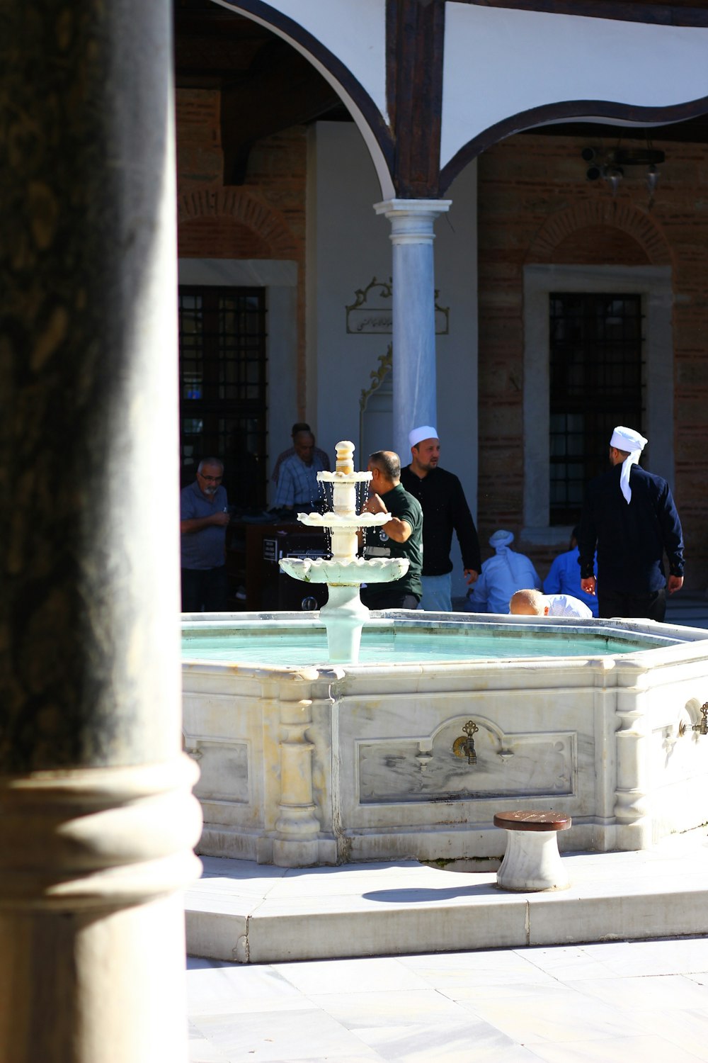 a group of people sitting around a fountain