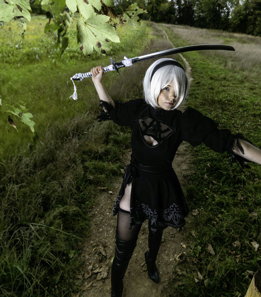 a woman with white hair holding a sword