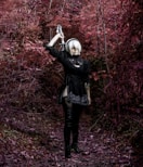 a woman in a black outfit holding a knife