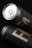 Two sleek black cans with a matte finish are placed at angles against a dark background. The label reads 'Black Can Mockup Templates' in minimalistic, modern typography. The top can is partially open, revealing a metallic pull tab.