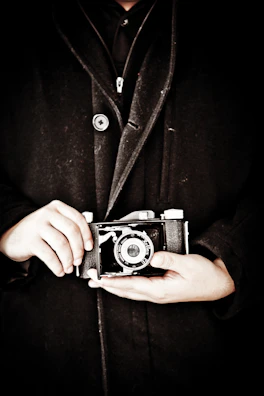Portrait of an elderly hands holding a vintage camera, telling a story of time and passion.