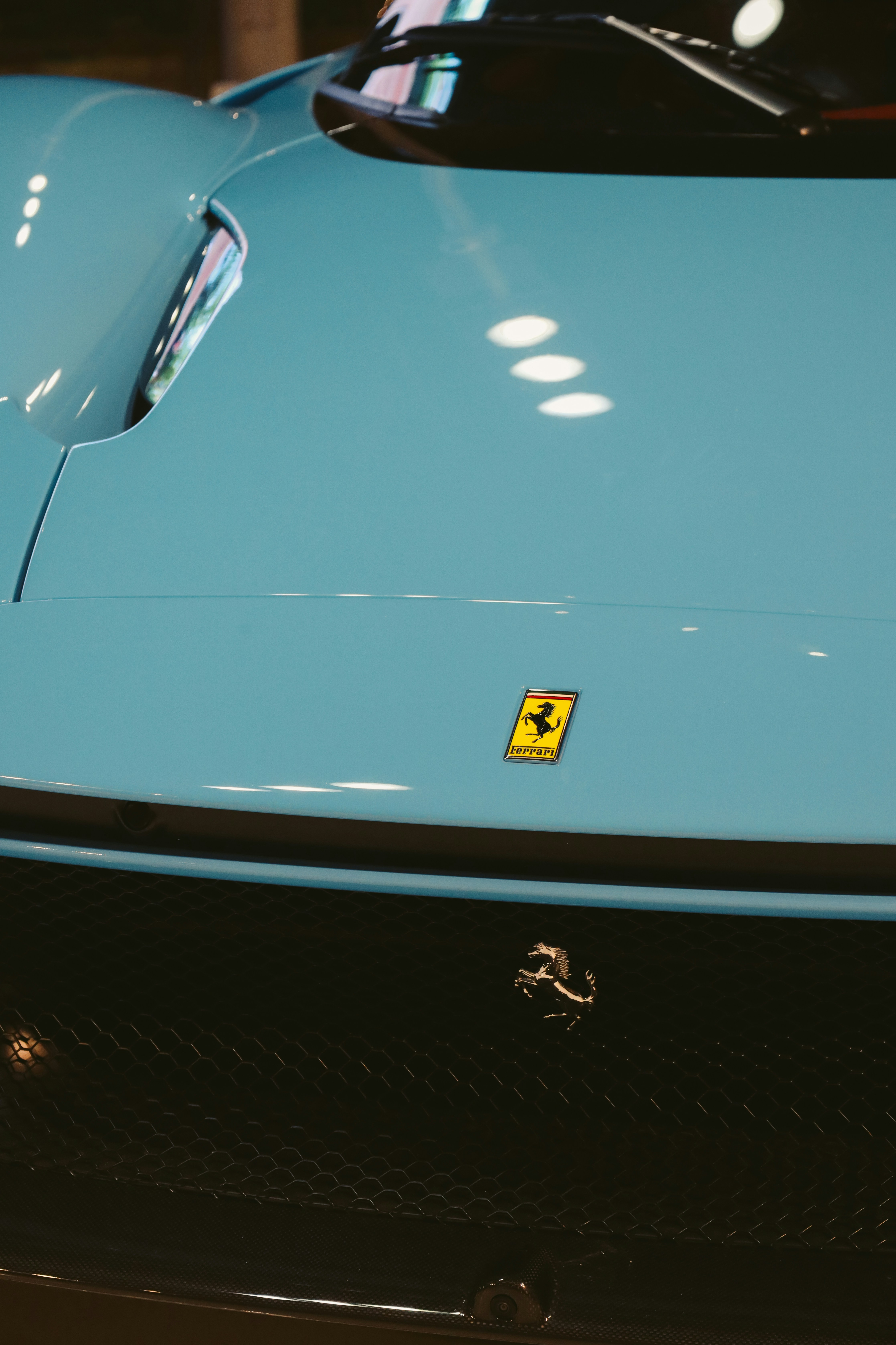 a close up of the front of a blue sports car