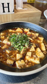 A vibrant bowl of palak tofu curry with creamy spinach and tender moongcraft cubes.