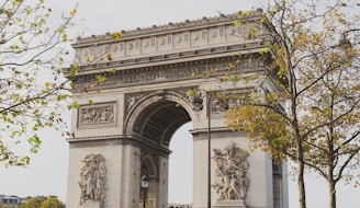 a large stone arch with statues on it