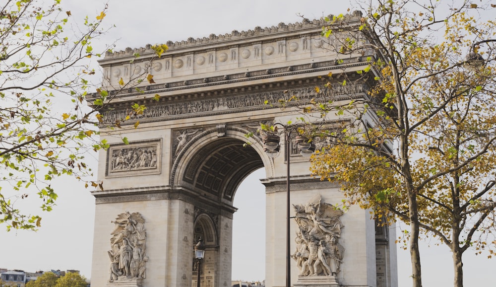 a large stone arch with statues on it