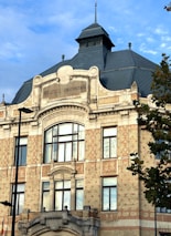 Historic buildings of Alexandru Ioan Cuza University bathed in warm afternoon light.