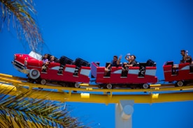A joyful family enjoying a colorful amusement park ride under bright sunshine