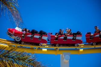 A joyful family enjoying a colorful amusement park ride under bright sunshine