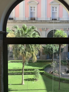 A lush hotel garden in Amman with vibrant flowers and neatly trimmed hedges under soft lighting