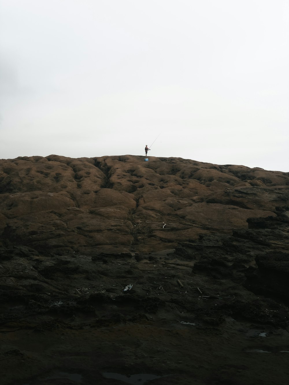 a person standing on top of a rocky hill