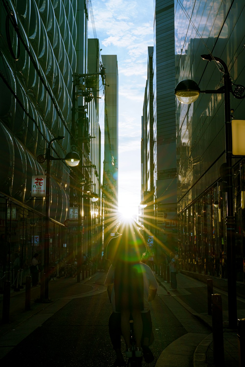 a man riding a bike down a street next to tall buildings