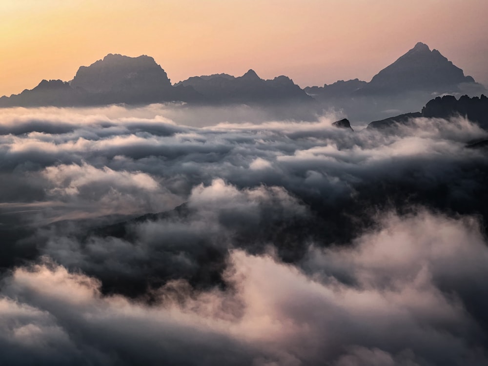 a view of a mountain range covered in clouds