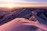 A peaceful sunrise over the Kedarnath temple surrounded by snow-capped mountains.