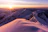 A peaceful sunrise over the Kedarnath temple surrounded by snow-capped mountains.