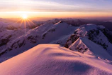 Sunrise painting the snow-capped mountains of Himachal Pradesh in warm hues.