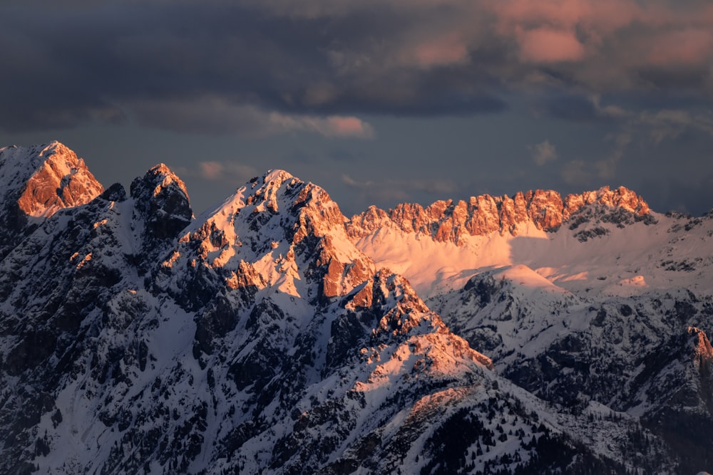 a mountain range with snow covered mountains in the background