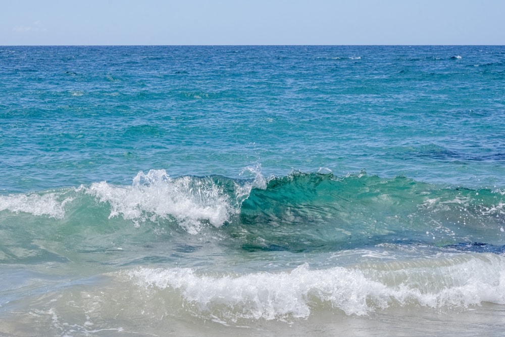 a person riding a surfboard on a wave in the ocean