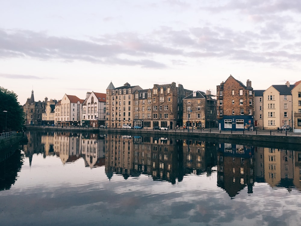 a body of water with buildings in the background