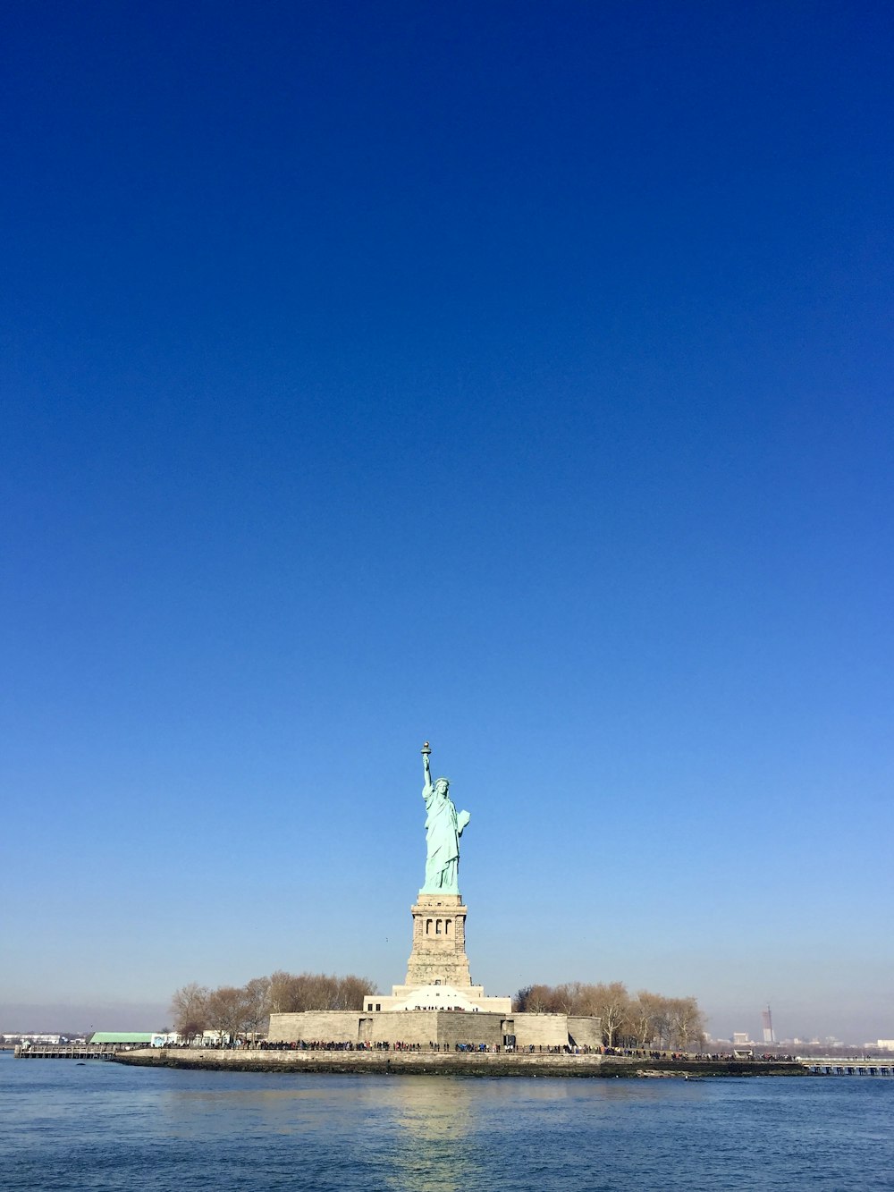 the statue of liberty is in the middle of the water