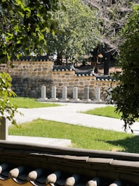 A serene garden showcasing native plants and dry stone masonry.