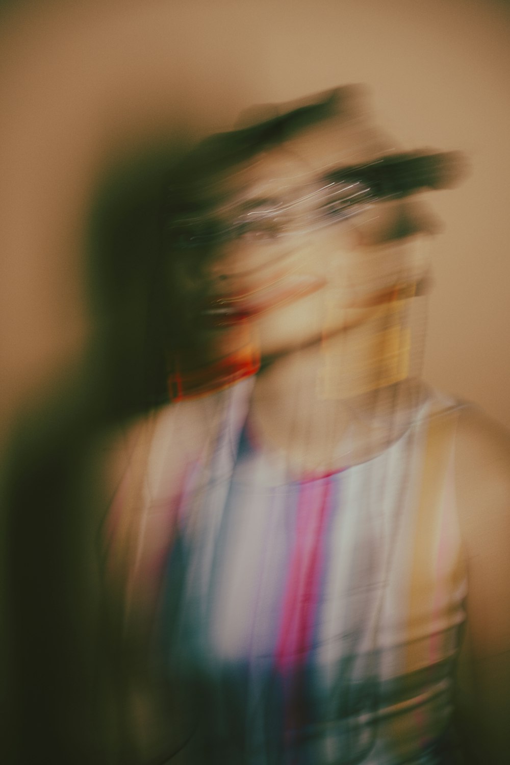 a blurry photo of a woman in a tank top
