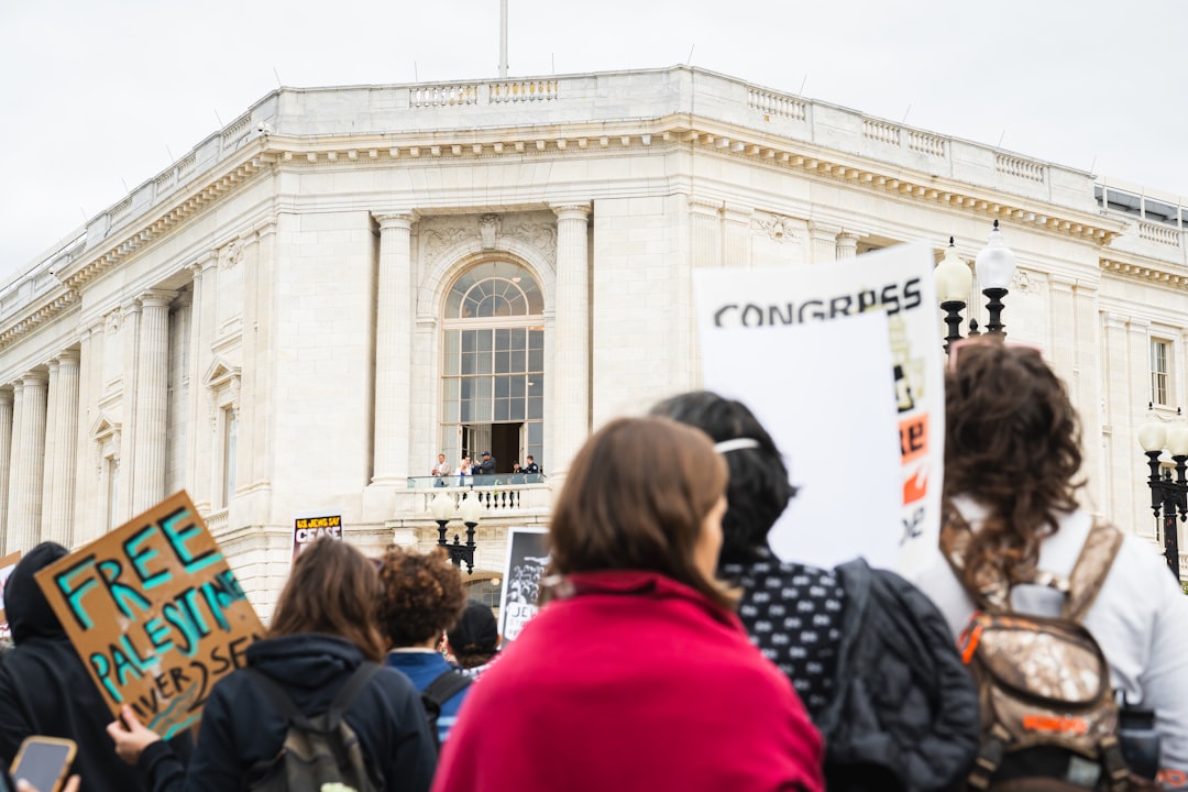 a group of people holding signs in front of a building, Free Palestine