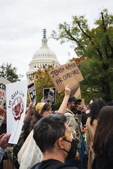 A peaceful protest in Potomac, Maryland, with diverse people holding signs advocating for human rights and democracy.