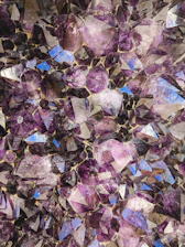 Close-up of sparkling amethyst crystals embedded in rock