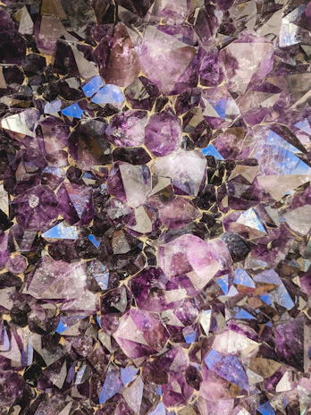 A close-up of a shimmering amethyst cluster catching the light.