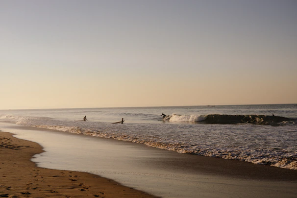 Sunlit waves rolling gently onto the shore at Playa de La Laja, perfect for surf school classes.