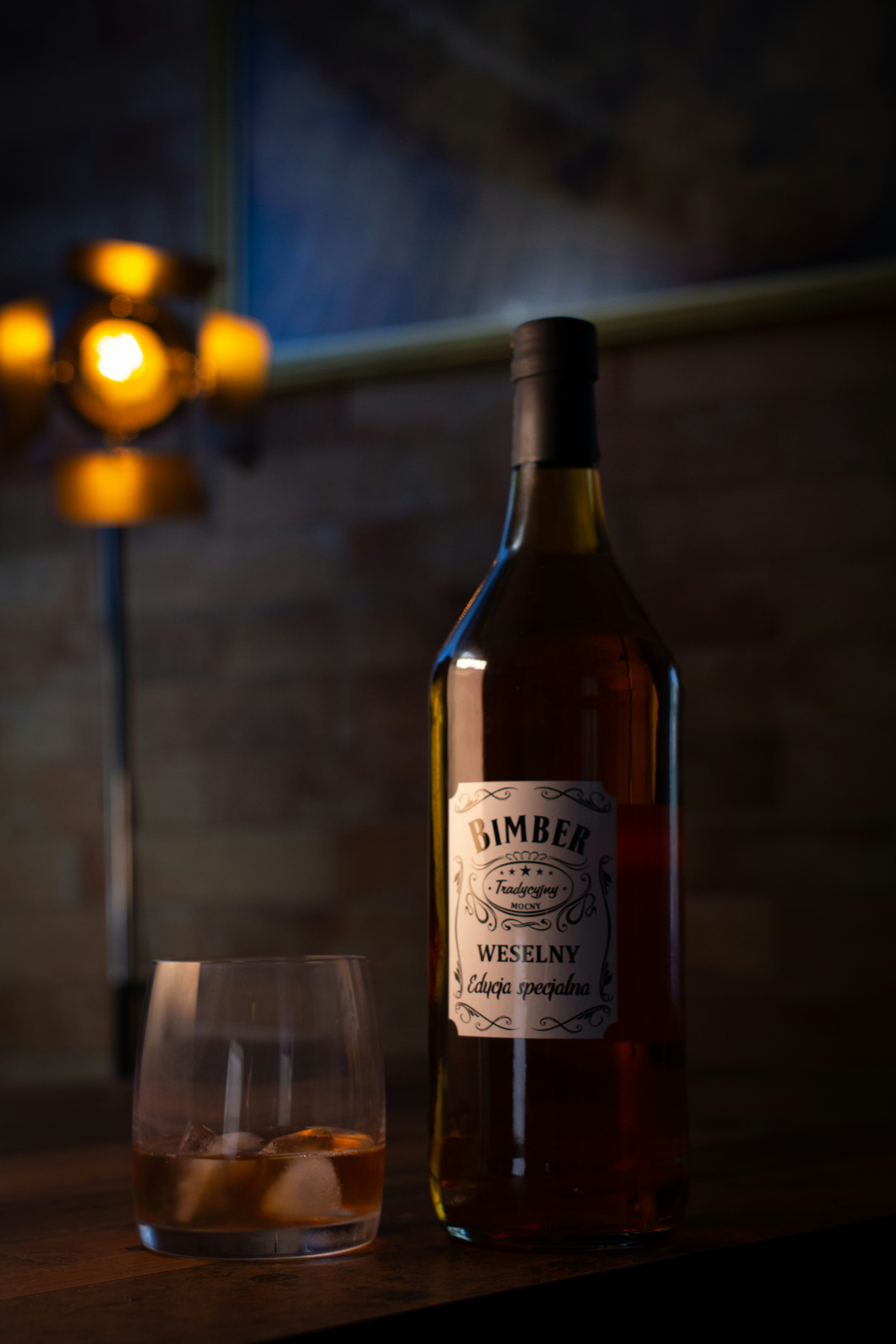 a bottle and a glass sitting on a table