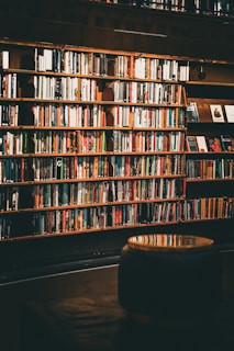 A bookshelf filled with colorful books and a tablet displaying a digital story, bathed in natural light.