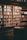 Close-up of a handcrafted wooden bookshelf with neatly arranged books and a warm lamp nearby.