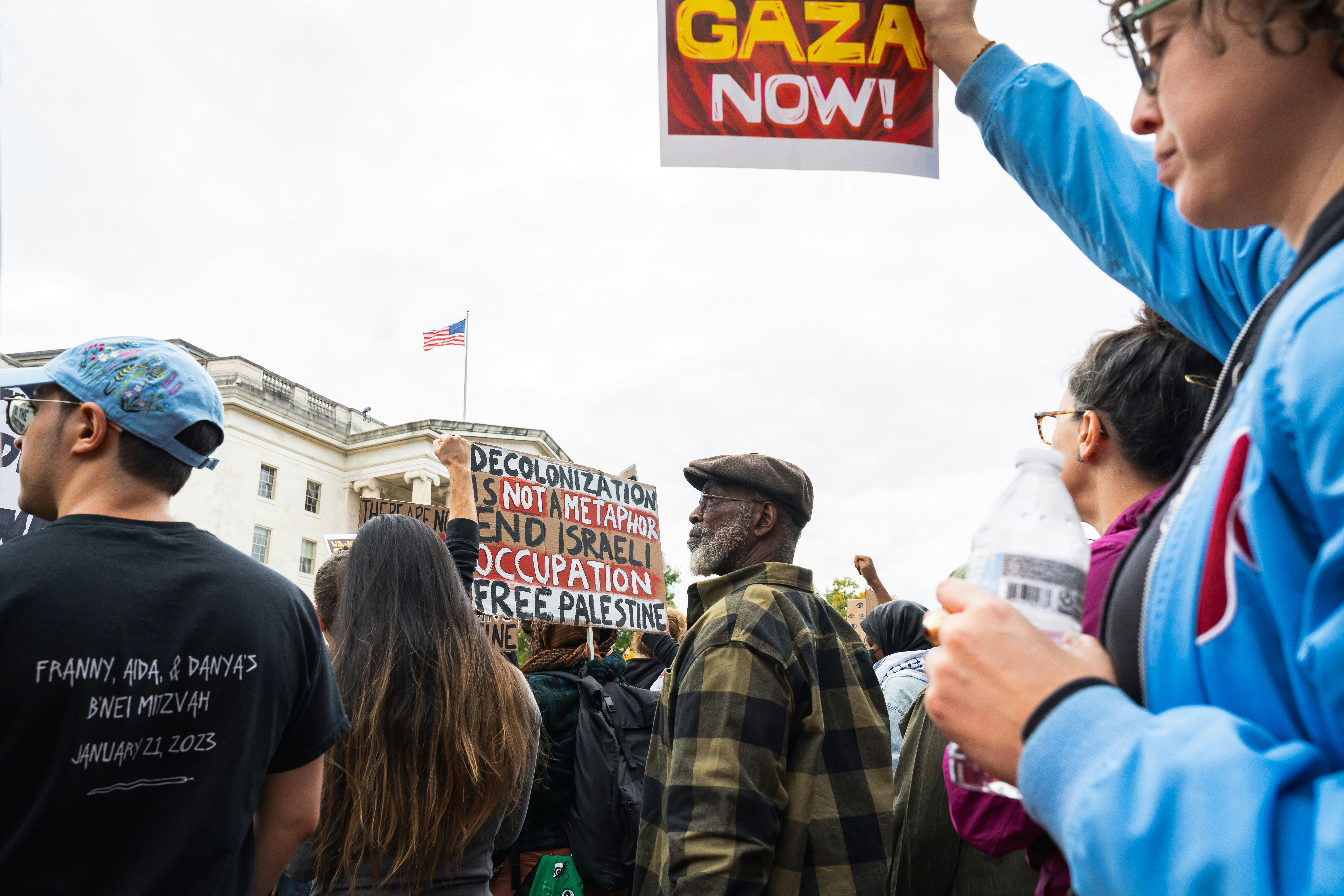 a group of people holding signs in front of a building, Decolonization is not a metaphor end Israeli occupation-free Palestine