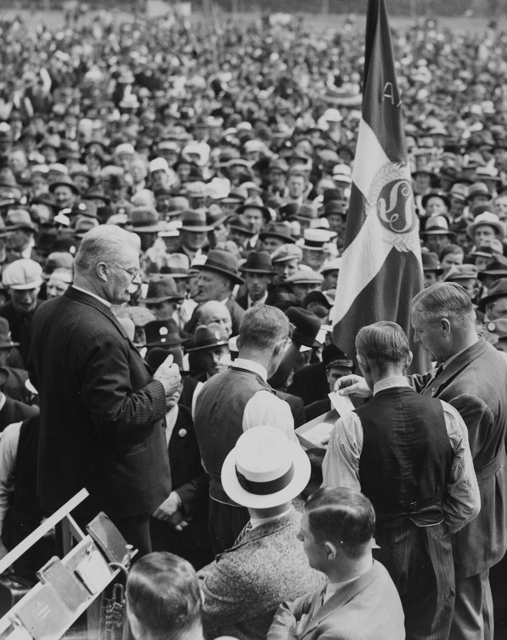 a crowd of people standing around each other