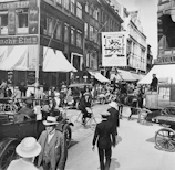 A still from a digitally restored historical documentary showing a bustling 1920s city street.