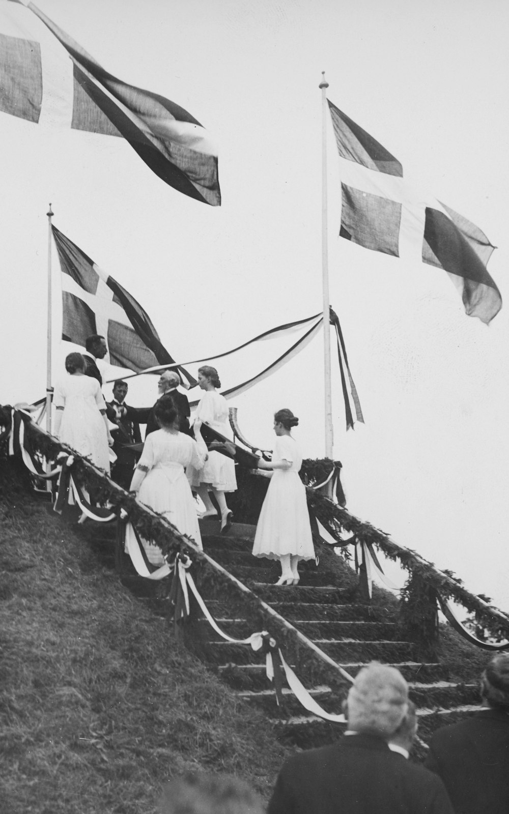 a group of people standing on top of a set of stairs