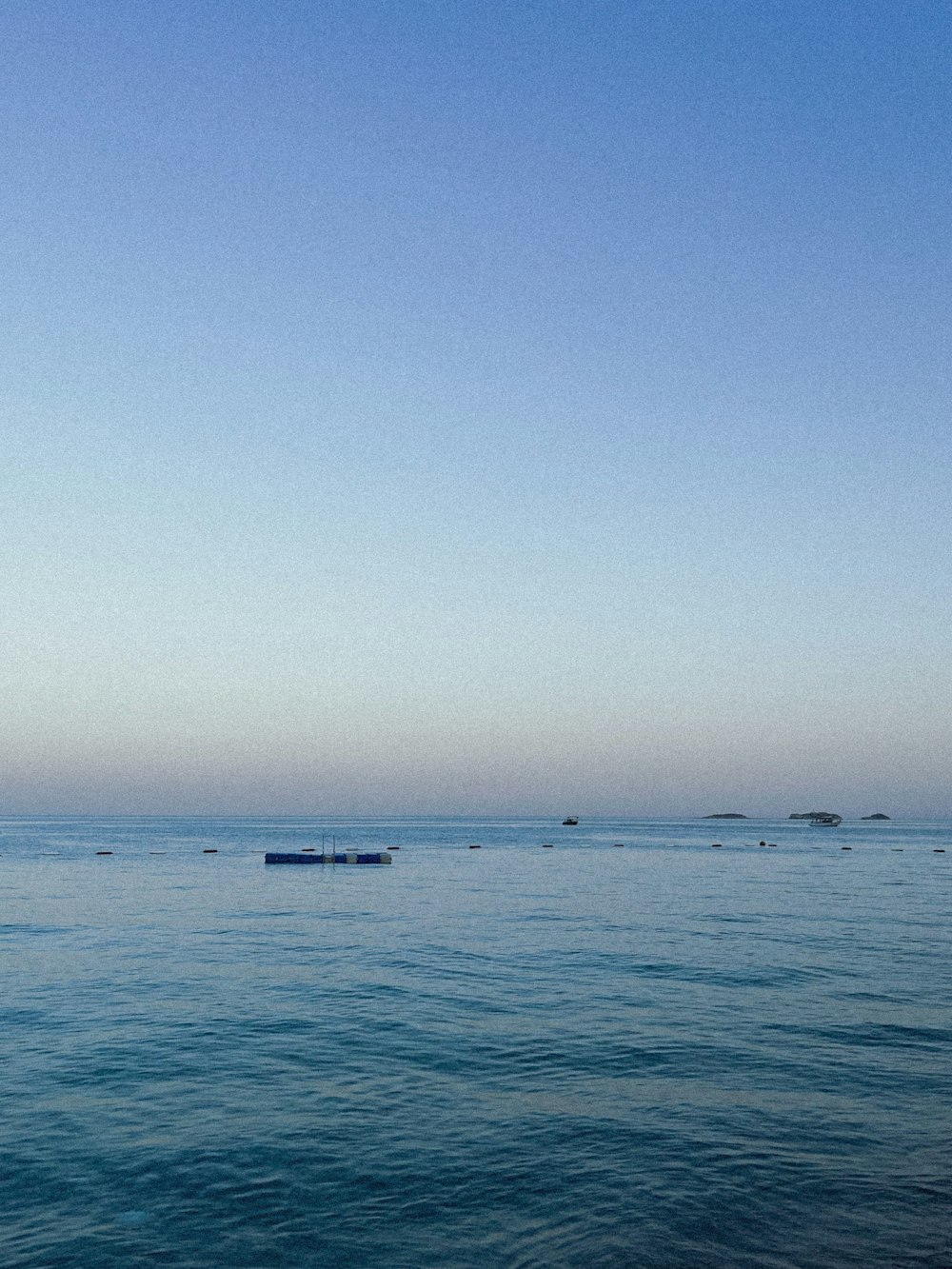 a large body of water with a boat in the distance