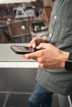 a man holding a cell phone in his hand